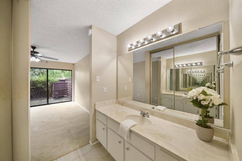 A view of the dressing area with the owner's bedroom in the background.