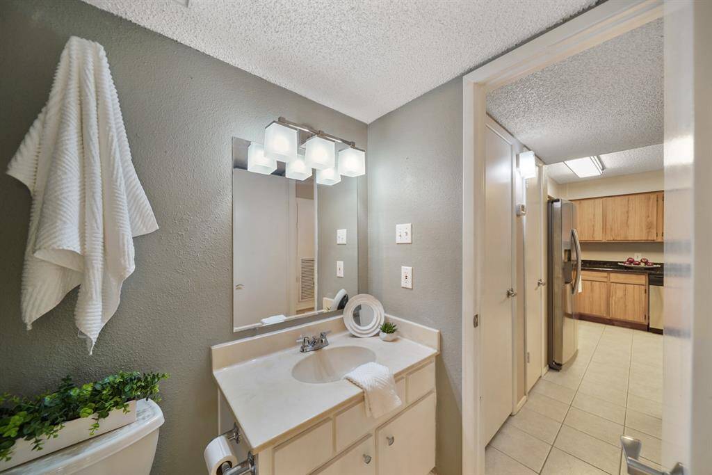 Perfect for guests, the semi-private water closet is accessible from the bedroom and the corridor off the kitchen.