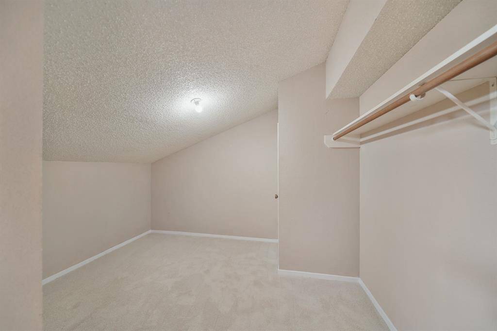 Need storage space? This 11' x 10' walk-in closet has ceiling mounted lighting & carpet.