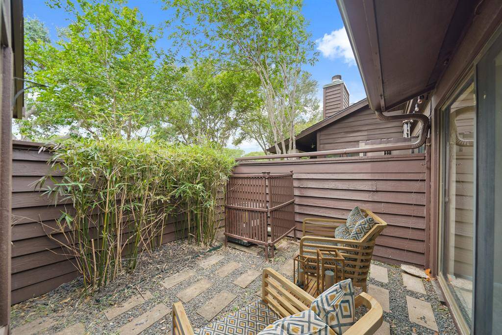 Surrounded by wood-stained fencing, this 11' x 11' patio is accessible from the living roomand the owner's suite. This photo has been virtually staged.