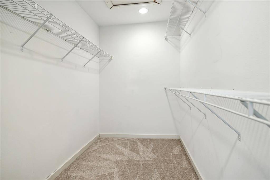 Walk in closet in the primary bedroom