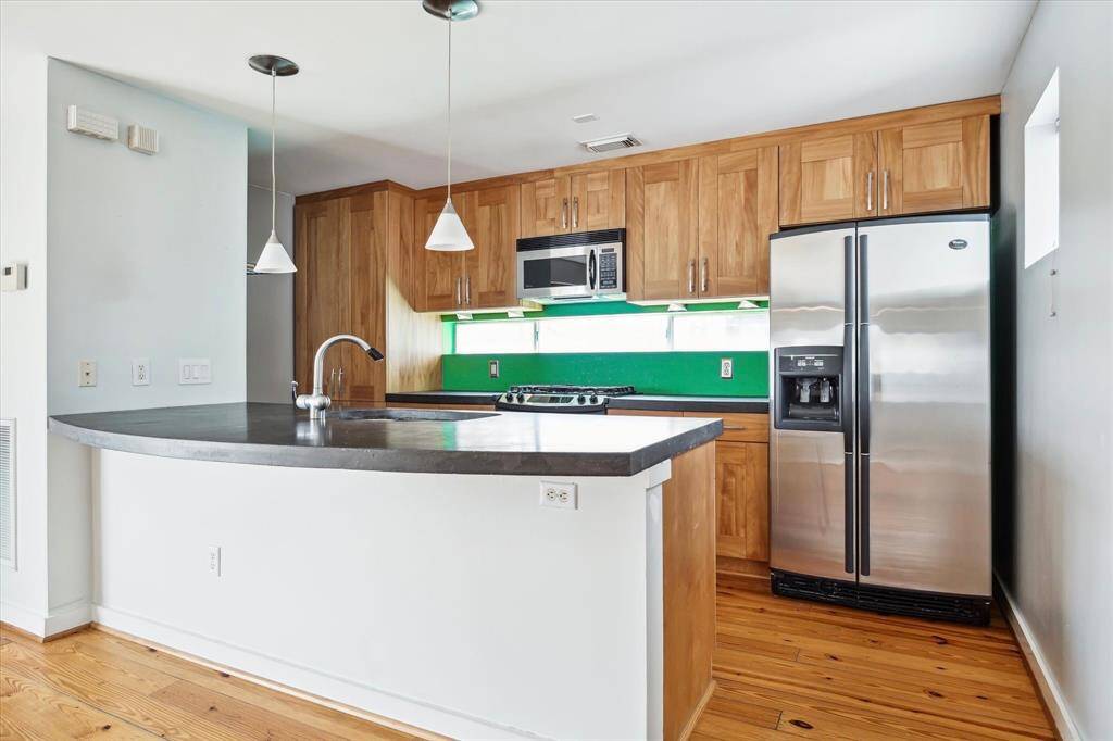 Granite counters, bar seating, and stainless steel appliances