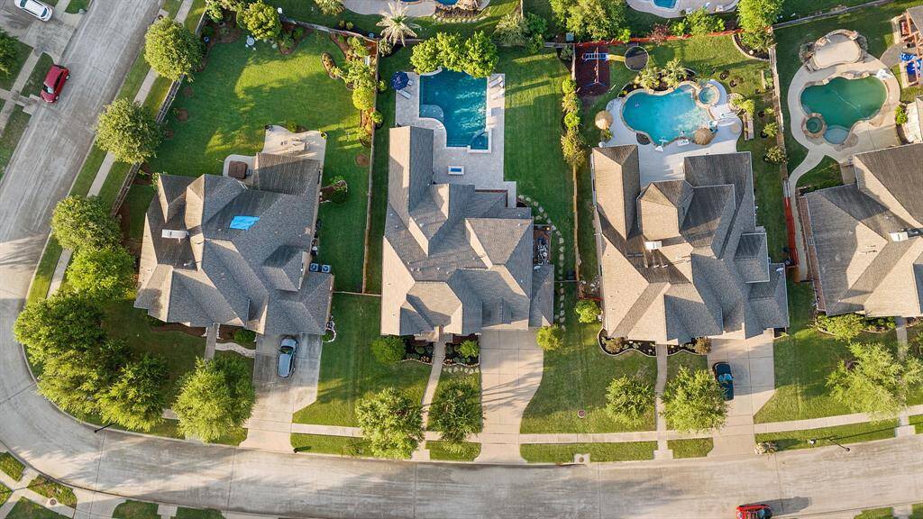 The property sits on a large lot at the end of a quiet cul-de-sac. It provides generous space between neighboring homes. From above, the long driveway and spacious yard layout are clearly visible. Take a moment to appreciate the tranquility and privacy of this stunning home.