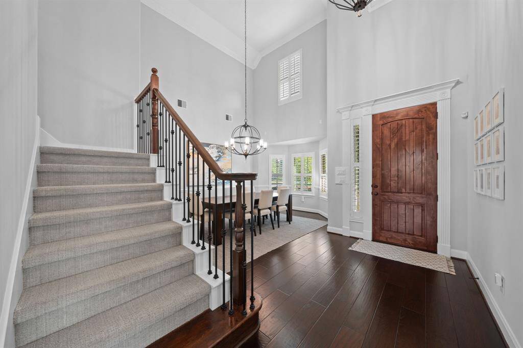 Upon entering the home, you are welcomed by soaring walls, elegant crown molding, and exquisite wood flooring that flows throughout.
