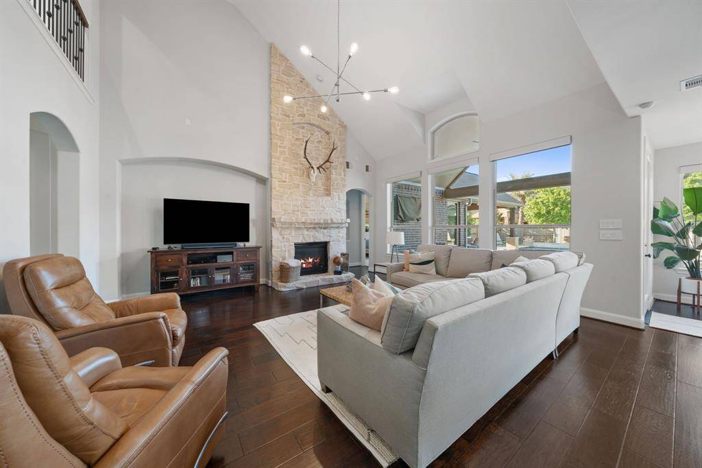 The family area features elegant electric Lutron shades that provide a quiet and precise control of natural light at the touch of a button. The stone fireplace extends all the way to the ceiling.
