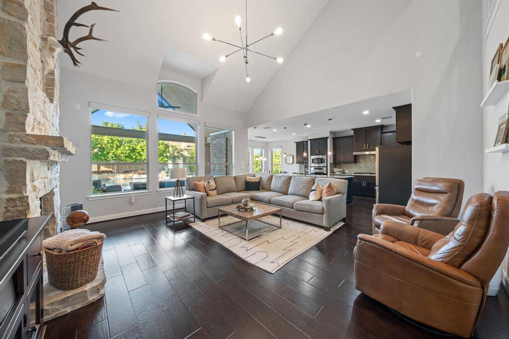Anchored by a new chandelier overhead, the family room breathes pure beauty while windows facing the backyard fill the space with serene views and natural light.