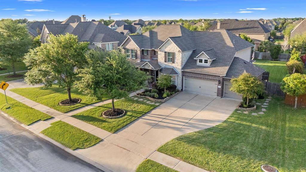 A long driveway leads gracefully up to the home, enhancing its curb appeal and providing ample parking space.