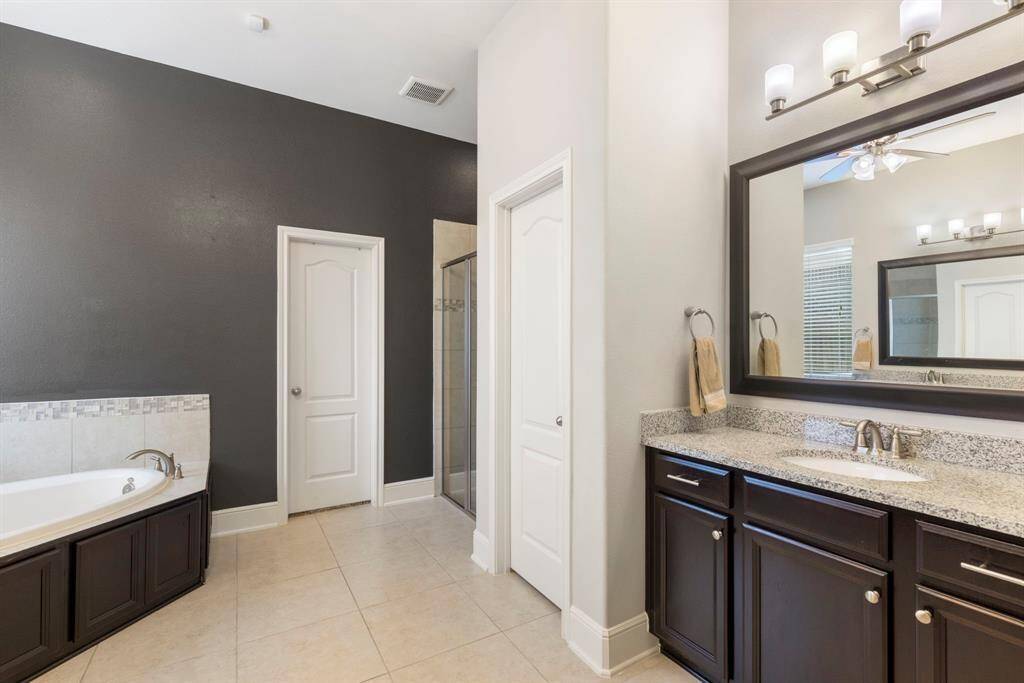 The primary bathroom showcases dual sinks, soak-in tub and separate shower!