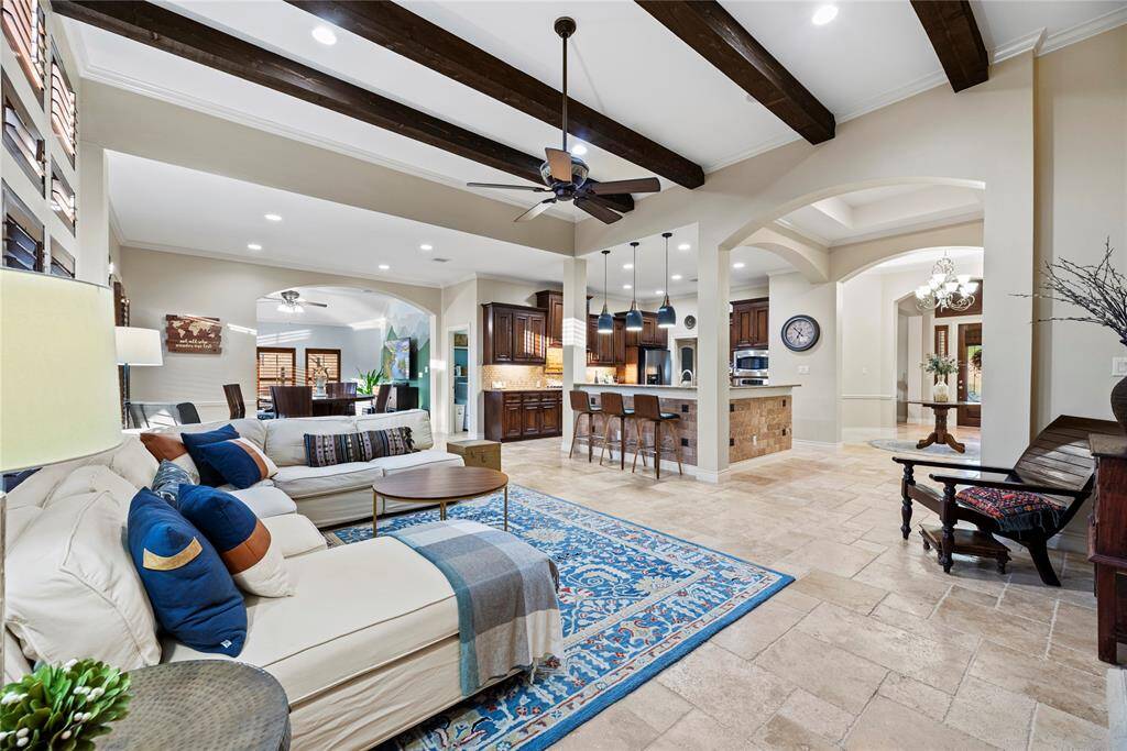 The living room, adjacent to the kitchen and breakfast area, offers a comfortable and inviting space for relaxation and socializing.