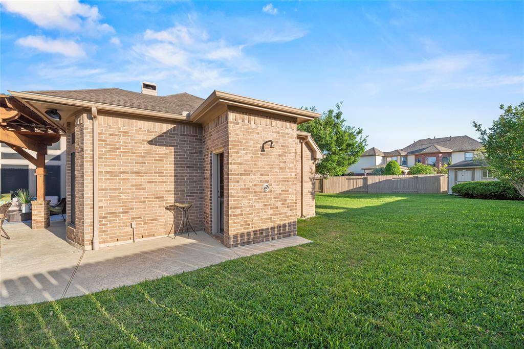 The conveniently located outdoor half bath by the pool adds both function and comfort, allowing guests to freshen up without tracking through the home.