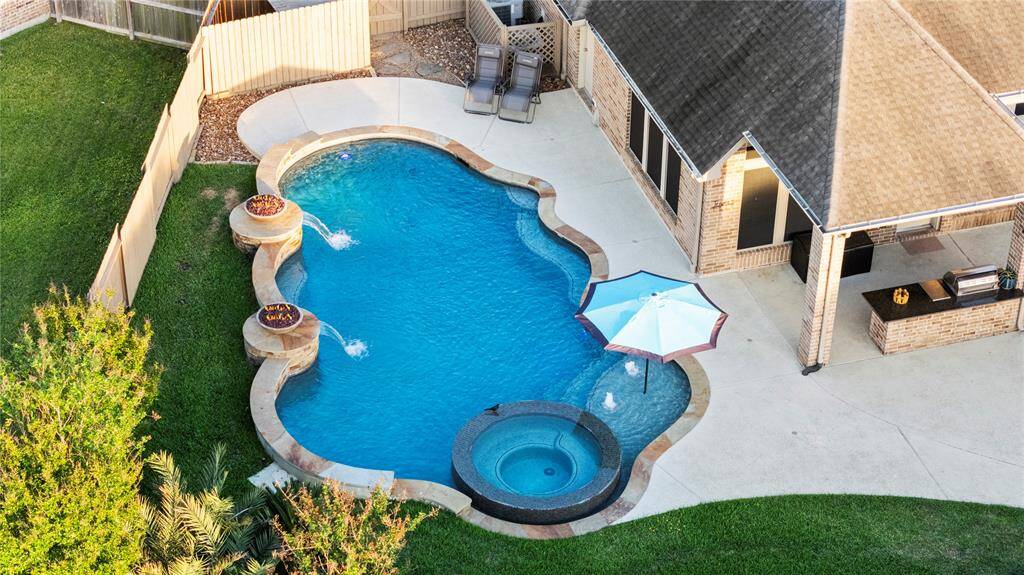 From this aerial view of the back of the home, you can fully appreciate its beauty, elegance, and remarkable charm. This property offers everything a family could wish for and more.