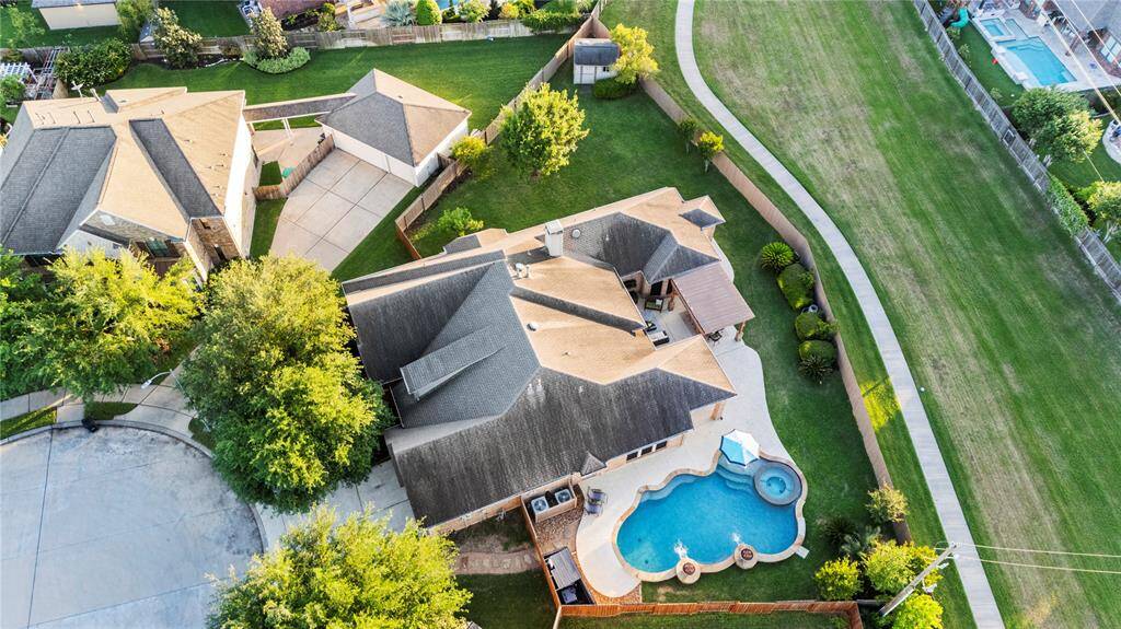The lush backyard surrounds a sparkling pool, creating an idyllic oasis. With ample space for outdoor living and recreation, this lot offers a rare combination of openness, seclusion, and luxury.