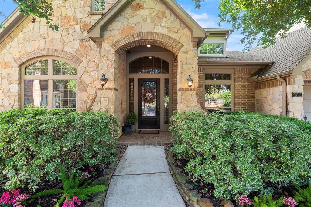 The stone and brick exterior exudes charm and elegance, creating exceptional street appeal that captivates at first glance.