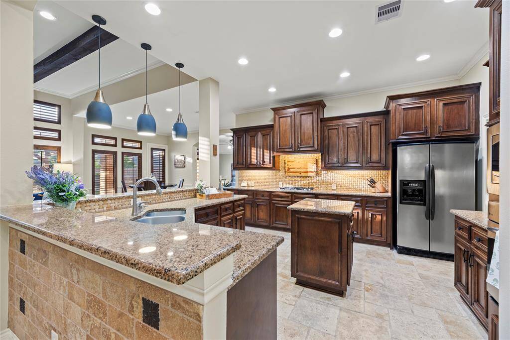 Granite countertops paired with a coordinating backsplash not only provide a durable and elegant surface for food preparation but also add a touch of luxury and sophistication to the kitchen.