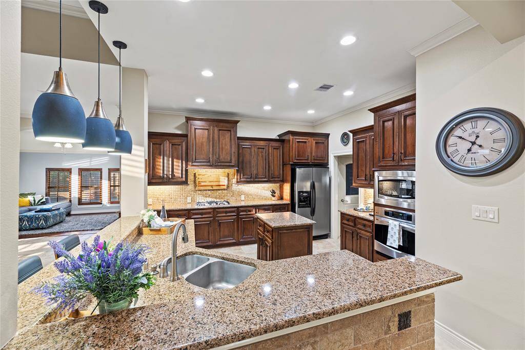 Rich cabinetry offers a clean, timeless aesthetic that elevates the space with a sense of brightness and openness.