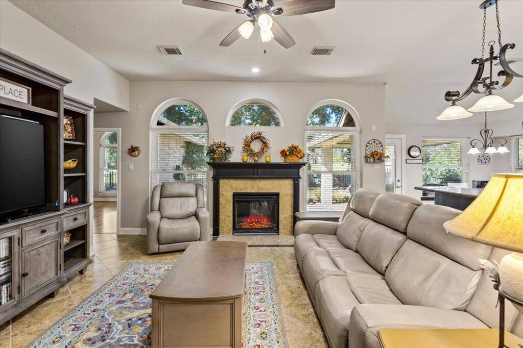 The mock fireplace adds a charming touch to the living room, perfect for hanging stockings during the Christmas season. Not only does it enhance the cozy ambiance, but it also provides warmth, making it an inviting spot for family gatherings and winter evenings.