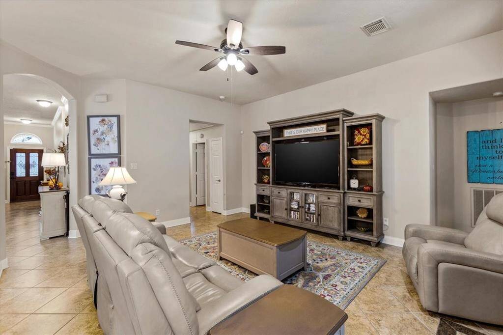 Another perspective of the home showcases its open layout, which thoughtfully separates the secondary bedrooms from the primary suite. This design enhances privacy while maintaining a spacious feel, making it an ideal setup for families or guests.