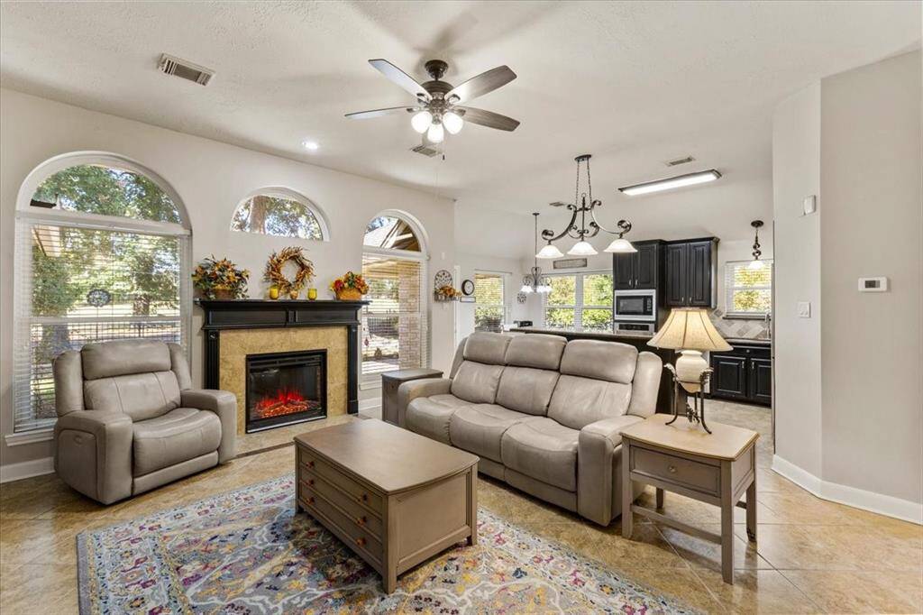 Unwind in elegance with the living room's captivating golf course vistas, perfect for serene relaxation or lively entertaining.