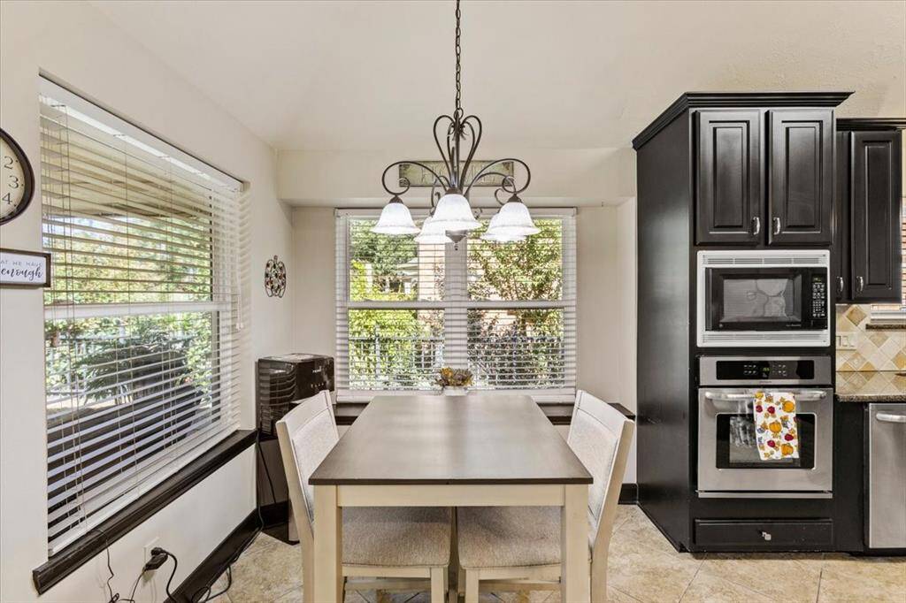 Enjoy tranquil breakfasts in this cozy nook, nestled under the gentle shade of the porch. With its fluid connection to the kitchen and living area, it's the perfect space for relaxed dining and easy entertaining.