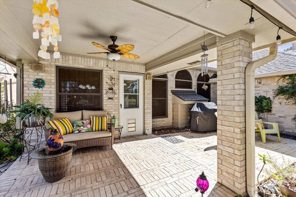 The breakfast room offers a delightful view of the covered porch, creating the perfect setting for enjoying cocktails after a long day at work. This inviting space seamlessly blends indoor and outdoor living, making it ideal for relaxation and unwinding.