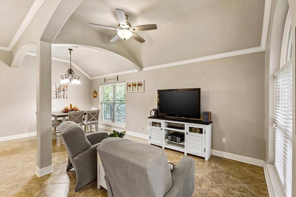 Discover the elegance and adaptability of this sunlit living room, ideal for your home office, media lounge, or serene reading nook. Embrace the sophistication and comfort designed to enrich your everyday living.