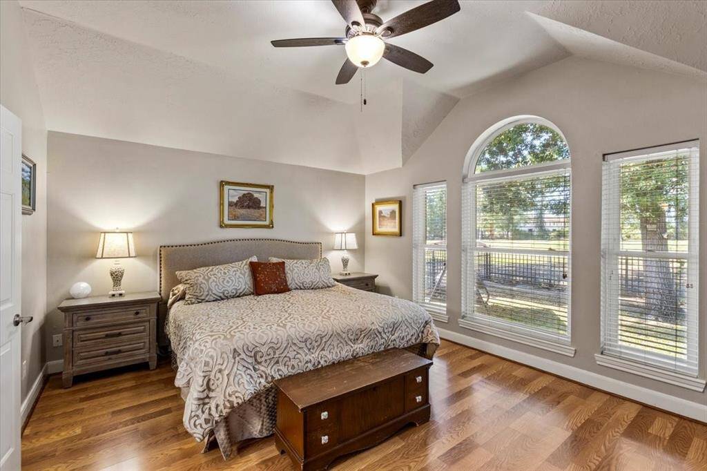 The primary bedroom, conveniently located just off the living room, features stunning views of the golf course. Adorned with beautiful laminate flooring, this tranquil retreat combines elegance and comfort, creating an inviting space to relax and unwind.