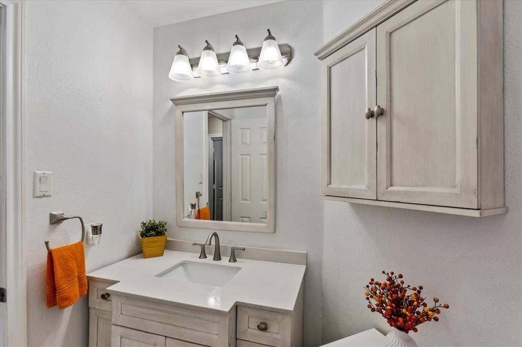 The secondary bathroom has been beautifully updated, featuring modern fixtures and stylish finishes that create a fresh and inviting atmosphere. With its thoughtful design and attention to detail, this space combines functionality with a touch of elegance.