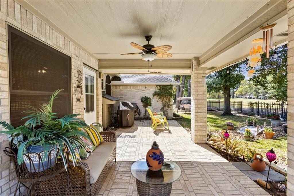 Step into your cozy, brick-accented porch with a breezy, ceiling-fan-equipped patio that promises year-round delight. It's the perfect spot for morning coffees or evening relaxation, offering a serene backyard view.