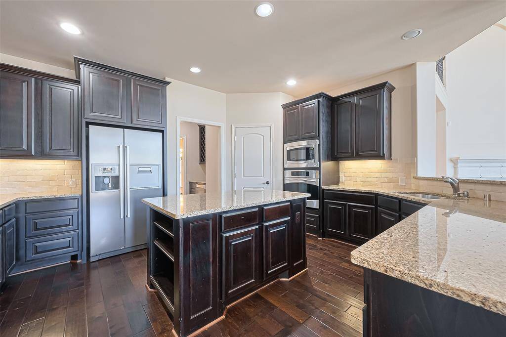 So much counter and cabinet space in this kitchen!  From this angle, you can see the separate pantry and doorway to the butler's pantry and formal dining room.