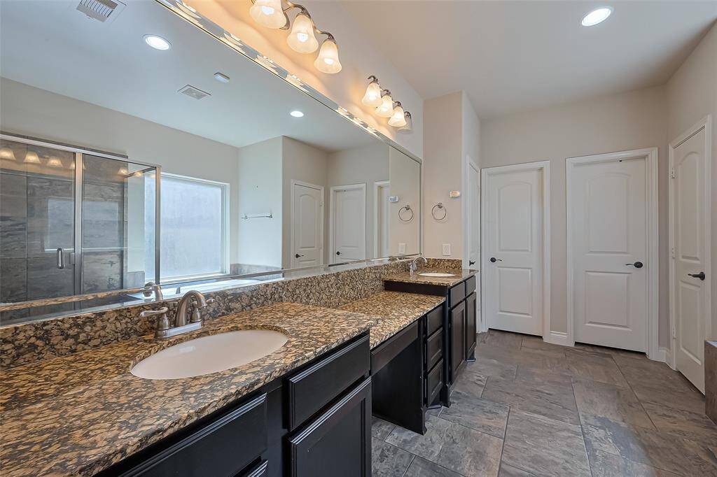 The primary bathroom has plenty of room for 2!  Double vanity and separate closets.