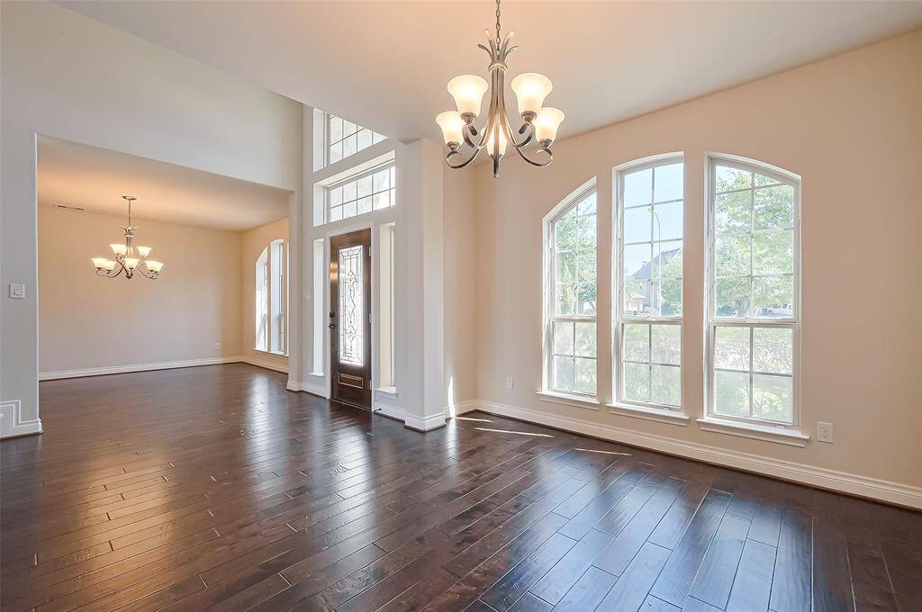 As you enter, the formal dining area is located to the right and to the left the formal living area would make a great home office space!