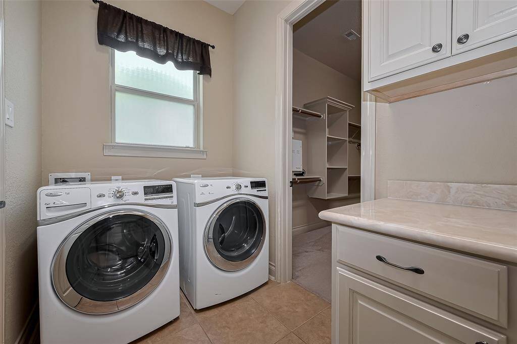 Convenient sink in utility room & room for all your storage needs.