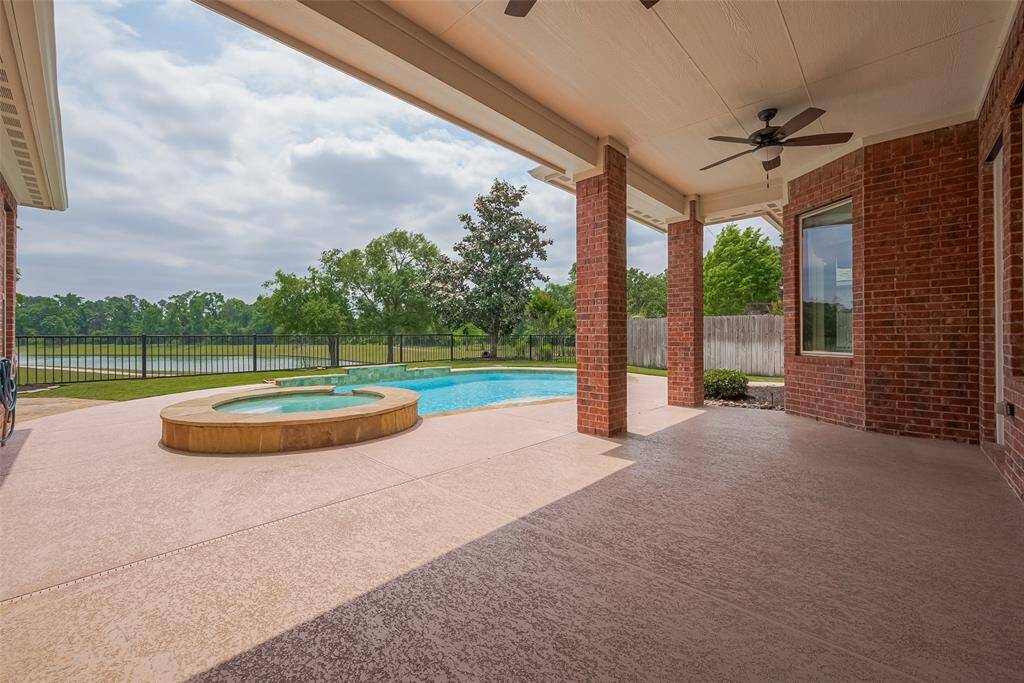 Game Room with Half Bath & Balcony Overlooking a Fantastic View of the Pool, Lake & Trees.