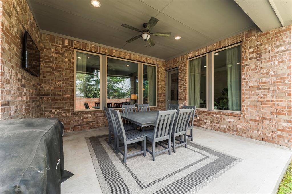 The covered outdoor patio features a ceiling fan and recessed lighting. The perfect space for entertaining.