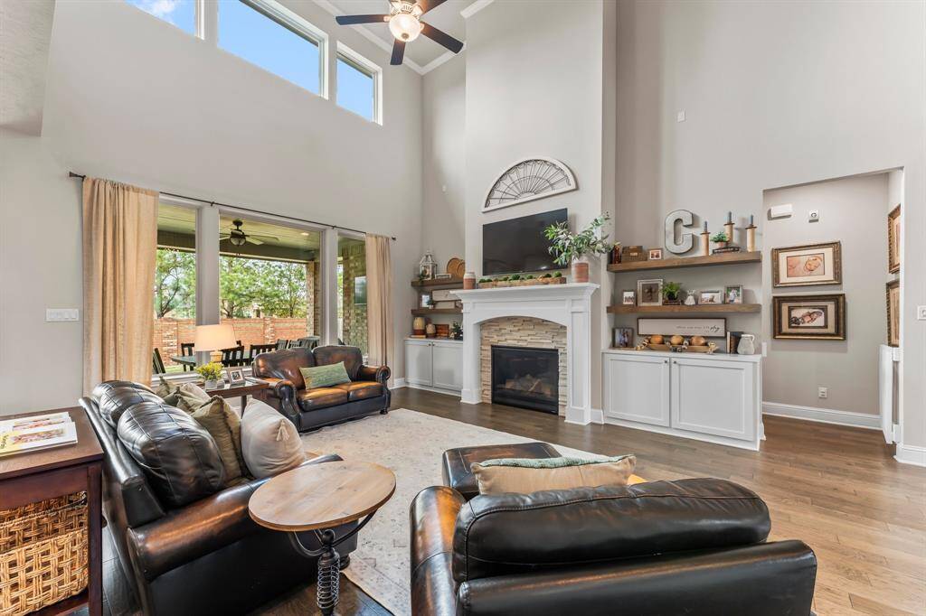 The space is tastefully enhanced by the custom cabinetry and floating decorative shelves on each side of the cozy fire place.