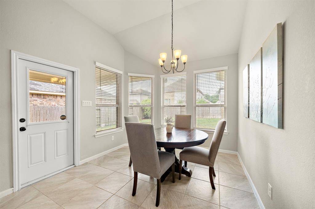 The dining area is located off of the kitchen and features a wall of windows allowing for plenty of natural light to come in.