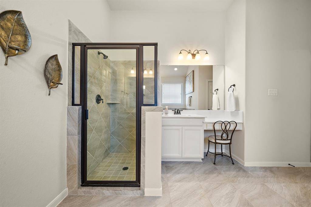 A view of the walk-in shower and sitting area.