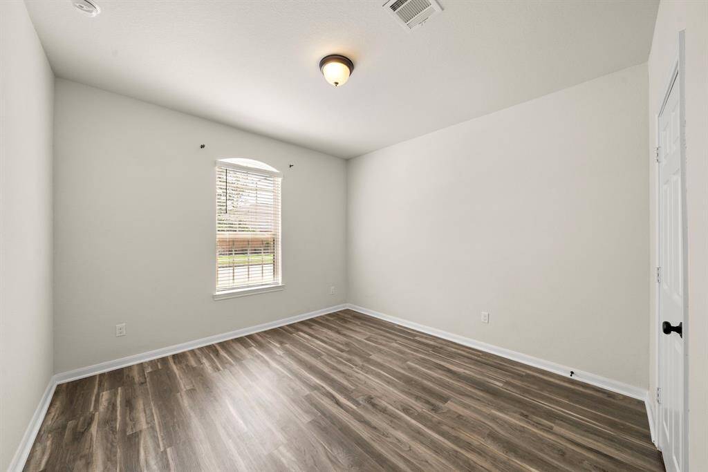 Secondary bedroom #2 located near the entry of the home.