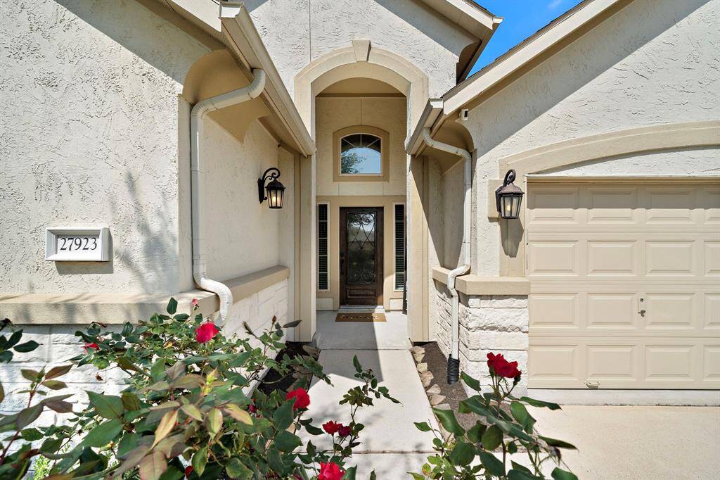 Gorgeous curb appeal with custom landscaping and a welcoming entryway.