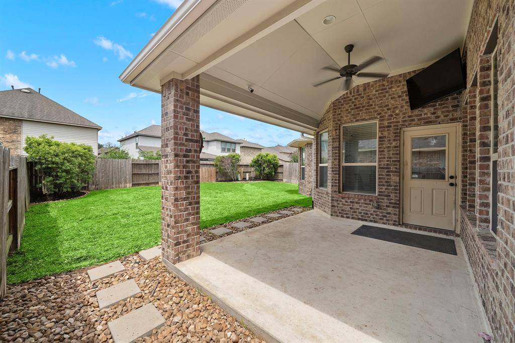 Outdoor covered patio featuring an outdoor fan.