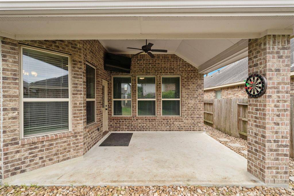 Another view of the outdoor coverd patio and custom rocks outlined around it.
