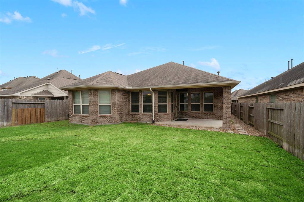 The backyard is large enough for a playset, pool, or garden!