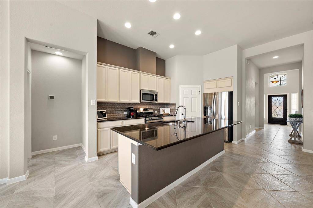 Another view of the wide hallway leading towards the kitchen.