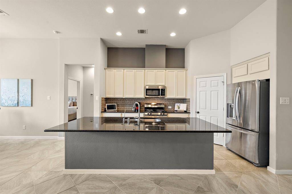 Gourmet kitchen featuring a hugh island with a breakfast bar for extra seating and entertaining.