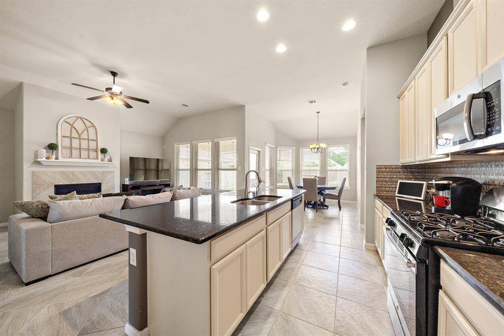 Featuring an open floor plan, the kitchen over looks the living room.