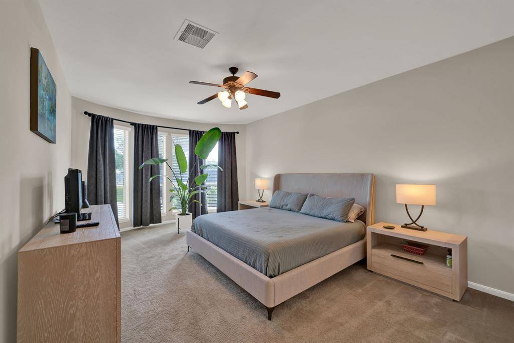 Huge primary bedroom with breathtaking pool views and lots of light!