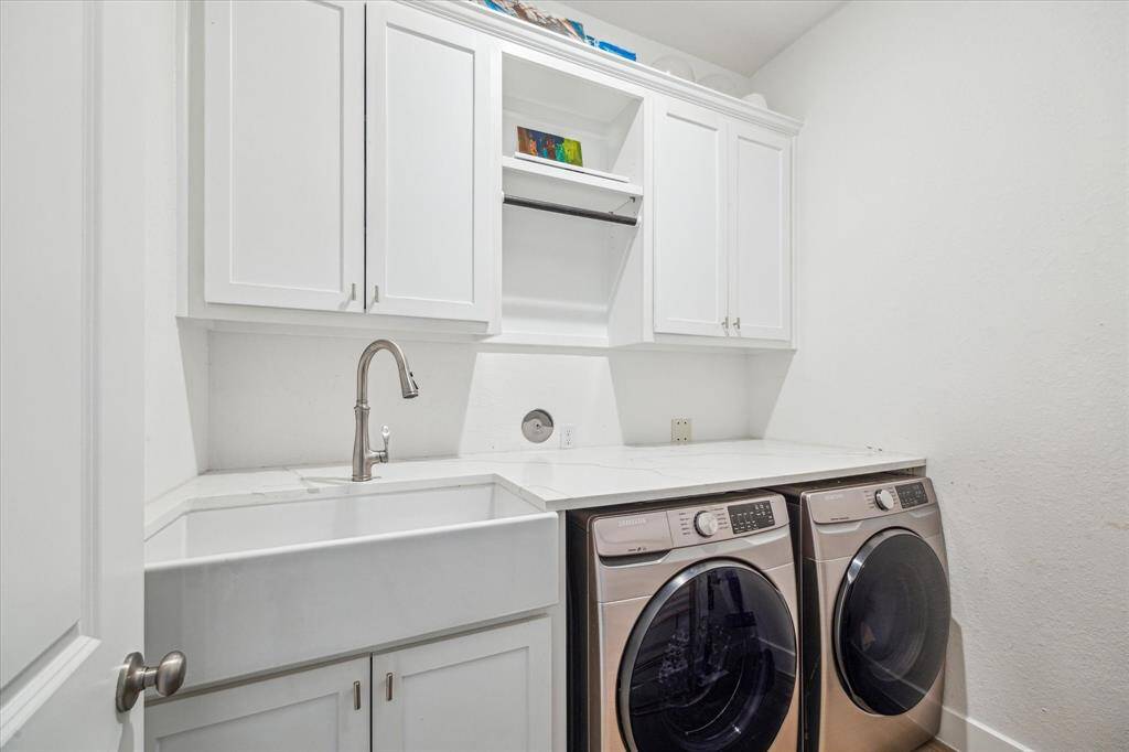 custom cabinets and farmhouse sink installed in utility room. Whole home water softener helps keep appliances running longer