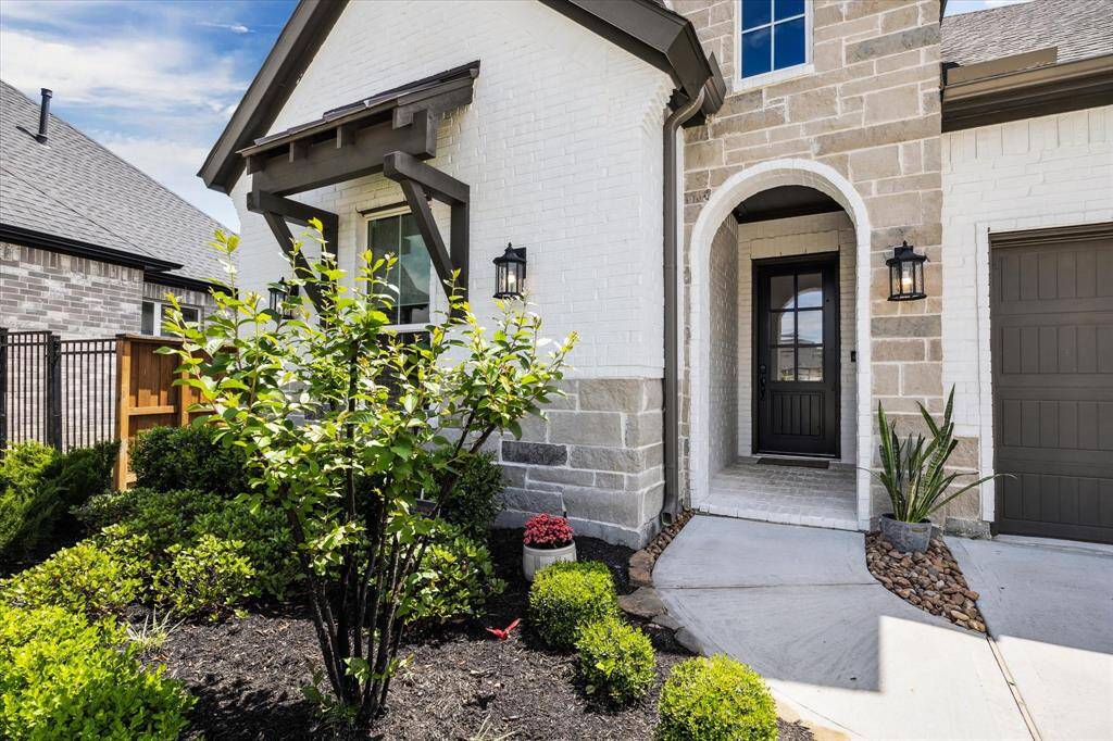Elegant and low maintenance landscaping surrounds front of home