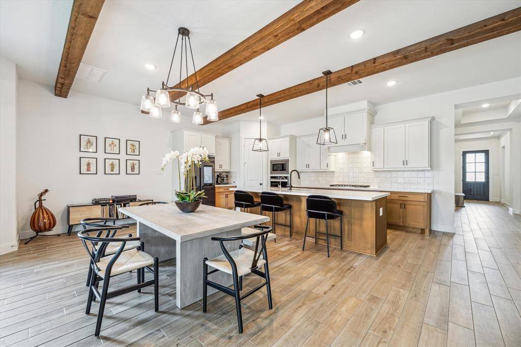 beamed ceilings and wood-look tile throughout the home