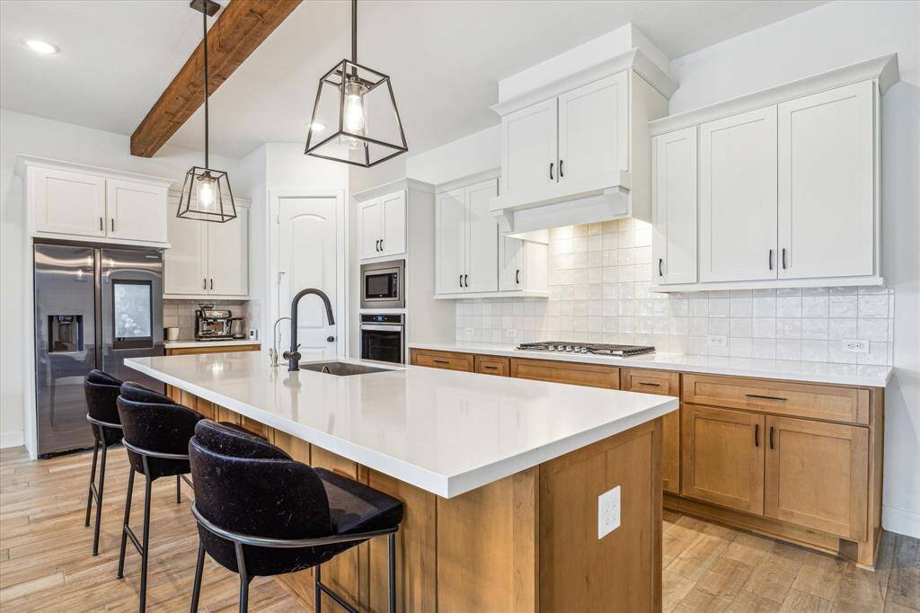 Light and bright with under cabinet lighting.  Omega Stone kitchen island